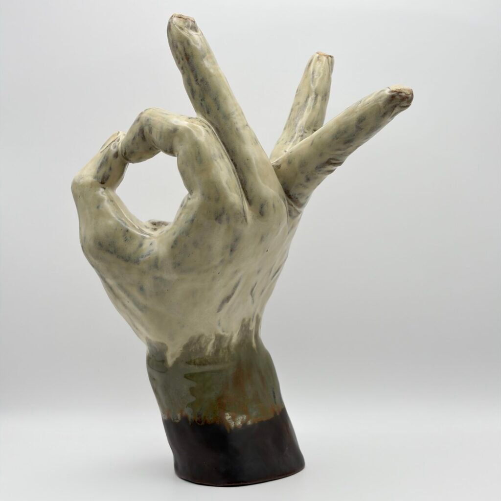 Handmade ceramic sculpture of a hand making an ok sign, made in the Isle of Man by JFC Ceramics