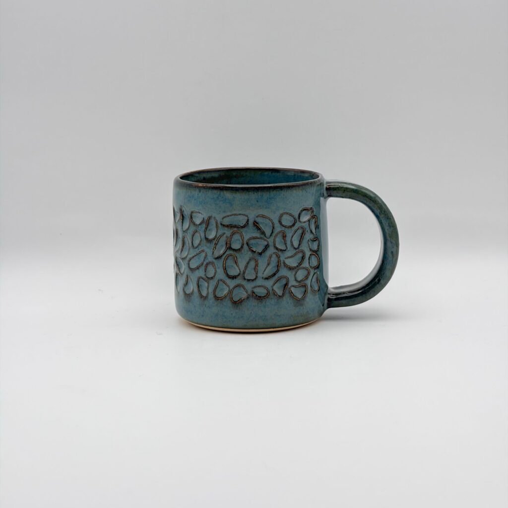 Handmade ceramic espresso mug with textured design in blue rutile glaze, made in the Isle of Man